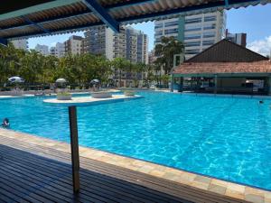 uma grande piscina azul numa cidade em Condomínio Ocean Park módulo 6 proximo a praia e shopping Riviera de São Lourenço em Riviera de São Lourenço