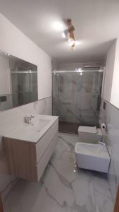 a bathroom with a sink and a toilet and a mirror at Greek Temple in Agrigento +37 photos
