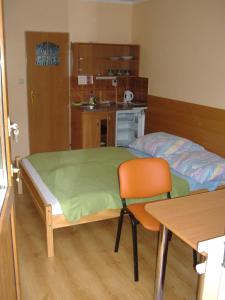 a bedroom with a bed and a table and a chair at Privat AVE in Liptovský Trnovec