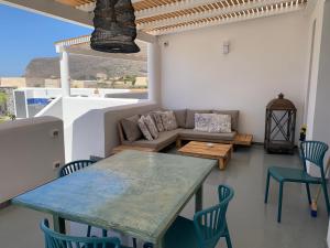 a living room with a table and chairs and a couch at Le Casuzze Ammare in Favignana