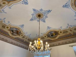 um candelabro pendurado num tecto num quarto em Le Muse em Pisa