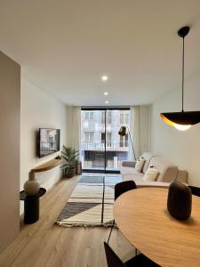 a living room with a white couch and a table at Reyes Católicos Premium Homes in Alicante