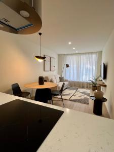 a living room with a table and a couch at Reyes Católicos Premium Homes in Alicante