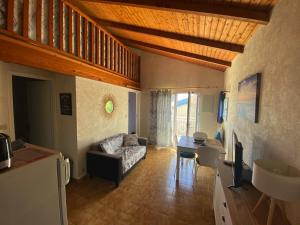 a living room with a couch and a table at Appartement à deux pas de la plage avec balcon-terrasse - FR-1-336-112 in Jard-sur-Mer
