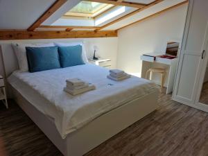 a bedroom with a large bed with a skylight at Anna24 Holidays in Vantačići
