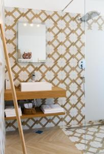 a bathroom with a sink and a mirror on a wall at Gallery Luxury Suites & Rooms-Only Adults in Split