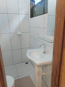 a white bathroom with a sink and a toilet at Morada da Lua in Foz do Iguaçu