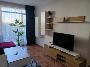 A television and/or entertainment centre at Sun Wave EXCLUSIVE