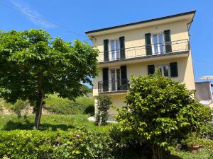 an apartment building with trees in front of it at Nonna Arde in Beverino