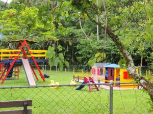 a playground with colorful play equipment in a park at Refúgio da família - serra & lago in Guapimirim