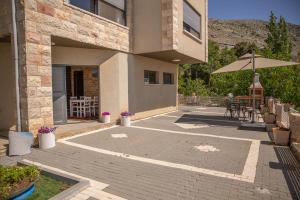 an outdoor patio with a table and an umbrella at צימר ענאן בגולן in Majdal Shams