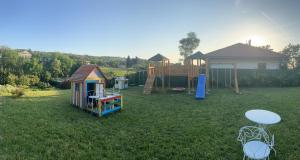 a yard with two play sets and a playground at Vila Lily in Smederevo