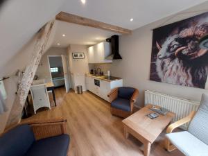 a living room with a couch and a table at Eursingerhof in Havelte +20 photos