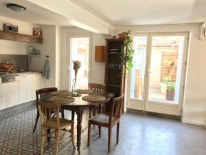 a kitchen with a table and chairs in a room at Appartement climatisé avec terrasse in Carcassonne