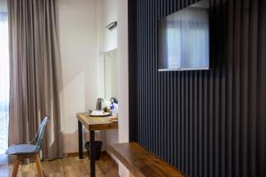 a room with a table and a chair and a television at Отель AuRoom Ванадзор in Vanadzor