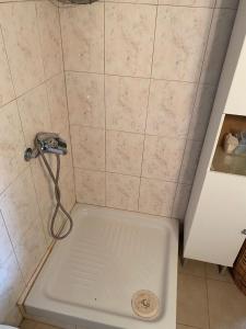 a shower in a bathroom with a sink at San Mamas Seaside Cottage-House, Large Garden and Caravan in Agios Mamas