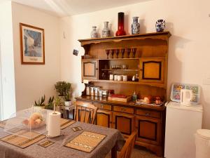 a kitchen with a table and a refrigerator at East of Ipswich Bed & Breakfast in Ipswich