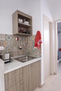 a kitchen with a sink and a counter at BleVista Apartments in Polychrono +82 photos