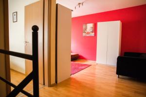 
a living room with a red wall and a red door at Elite Rooms & Apartments in Budapest
