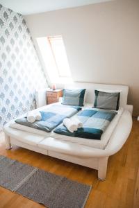 
a white bed sitting on top of a wooden floor at Elite Rooms & Apartments in Budapest
