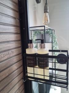 a shelf with candles and a light fixture at Barra's Loft in Fort William