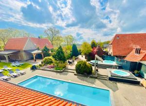 an overhead view of a house with a swimming pool at Wellnesshotel Spabron in Wachtum