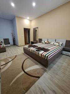 a bedroom with a large bed in a room at Семеен хотел Аристо in Dryanovo +4 photos
