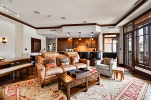 a living room with a couch and a table at Arrowleaf Lodge - 3 Bed Condo #302 in Park City