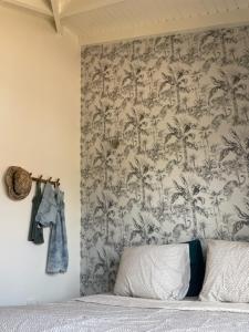 a bedroom with a wall with a wallpaper with palm trees at Kas Felis in Watervillas in Kralendijk