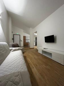 a bedroom with a bed and a tv on a wall at Terrazze Marinella - Appartamenti - Case vacanze in Pizzo