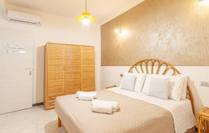 a bedroom with a large bed with towels on it at Affittacamere Nonno Natalino in Castelsardo