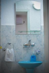 a bathroom with a sink and a mirror at Royal TSV Rooms in Sombor