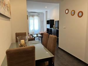 a living room with a table and a dining room at Apartamento Puente Romano in Córdoba