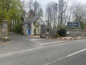a small building with a sign next to a road at 3 The Courtyard Castle Dargan in Ballygawley