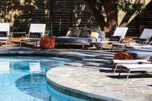 a swimming pool with chairs and a couch next to a patio at Kimpton Sylvan Atlanta - Buckhead by IHG in Atlanta