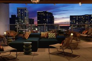 a couch on a balcony with a view of a city at Kimpton Sylvan Atlanta - Buckhead by IHG in Atlanta