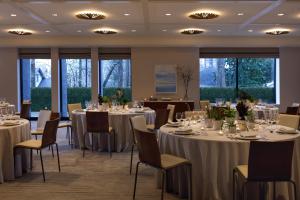 a banquet room with tables and chairs and windows at Kimpton Sylvan Atlanta - Buckhead by IHG in Atlanta