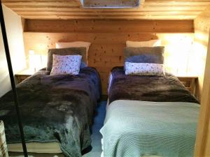 a bedroom with two beds in a log cabin at Appartement La Clusaz, 4 pièces, 7 personnes - FR-1-459-167 in La Clusaz
