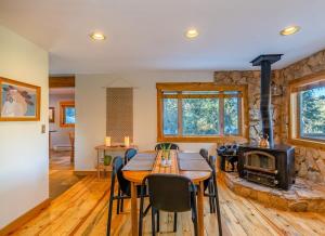 a dining room with a table and a fireplace at Cozy Cabin Perched on the Mountainside - Alpine Haus in Alma