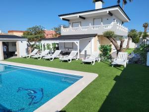 a villa with a swimming pool and a house at DREAM HOUSE in Burriana