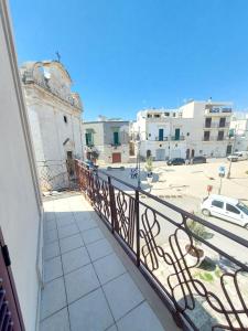 a balcony with a view of a street and buildings at Dimora Trinity in Polignano a Mare