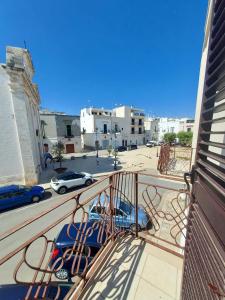 a balcony with a view of a parking lot at Dimora Trinity in Polignano a Mare