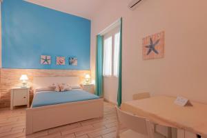 Posteľ alebo postele v izbe v ubytovaní Approdo Rooms - Eja Sardinia