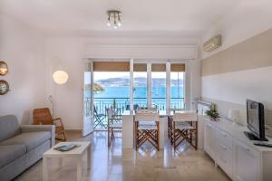 uma sala de estar com um sofá e uma mesa com cadeiras em Panoramica em Portovenere