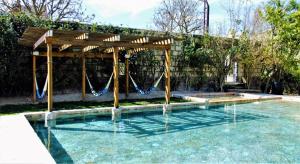 a swimming pool with a swing in the water at Hacienda San Patricio in San Miguel de Allende