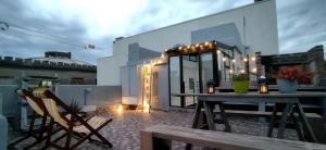 a balcony with a table and chairs on a building at House with large terrace, jacuzzi and gated parking for one car in Montevideo