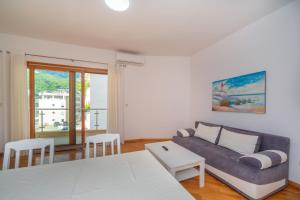 uma sala de estar com um sofá e uma mesa em Alex Lux sea view aparmtent 2 em Rafailovici