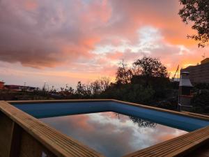 a swimming pool with a reflection of the sky at Casa Abuelo Yano in El Paso