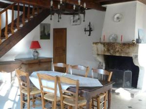 a dining room with a table and chairs and a fireplace at Gîte Contrisson, 4 pièces, 6 personnes - FR-1-585-16 