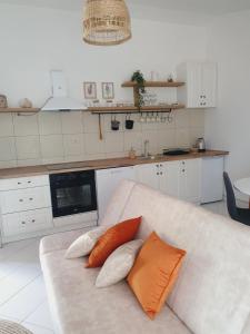 a living room with a couch with two pillows on it at Apartment Macic Dub II in Kotor +37 photos